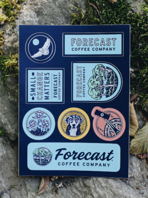 Forecast assorted sticker sheet sitting on top of a mossy rock